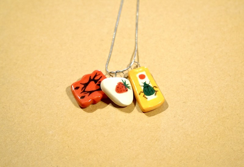 Three ceramic charms on a necklace